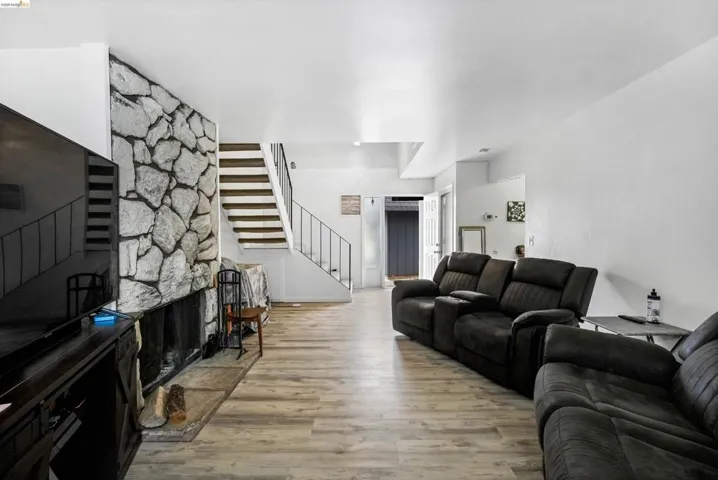 Living room featuring light wood-type flooring and a fireplace