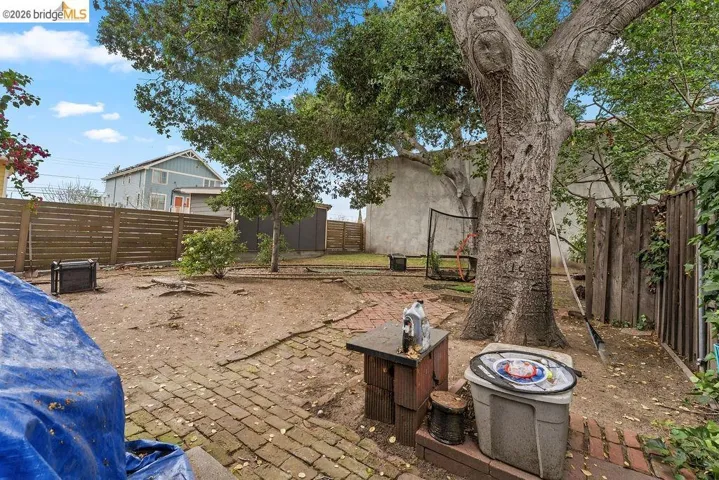 Fenced backyard with a patio area and an outdoor structure