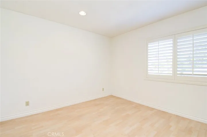 The second bedroom has wood shutters and recess ceiling lights.