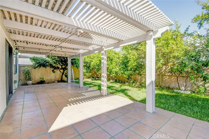 The covered backyard space with hardscape provides the perfect outdoor dining and gathering!