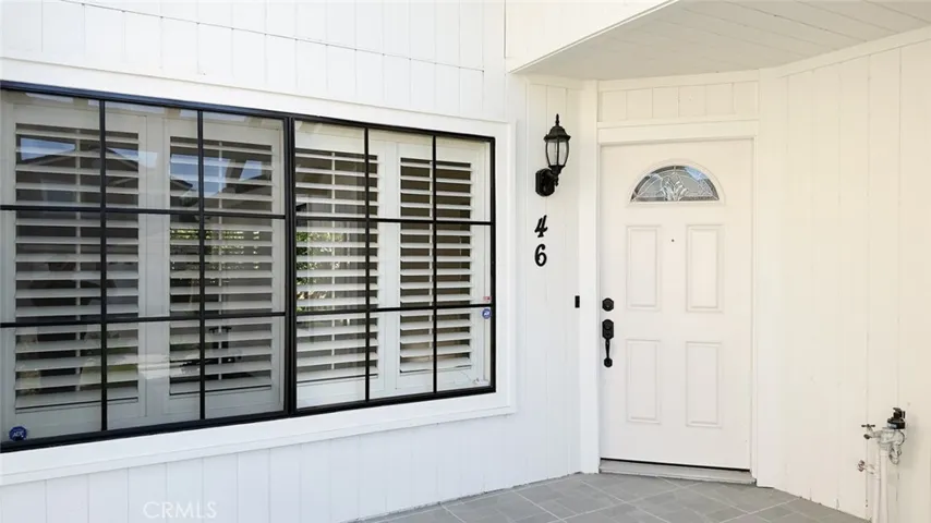 The living room window is next to the front door.