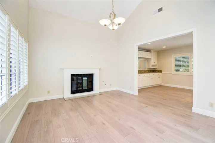 The living room with vaulted ceiling and breautiful floor. The wall between the living room and the family room was removed to create more light with better flow.