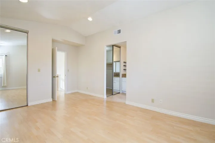 The primary suite has two walk-in closets with mirrored doors.