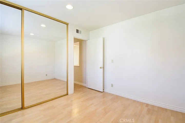 The second bedroom with mirrored closet doors.