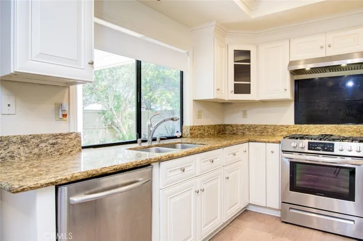 The large window above the kitchen sink has a view of the backyard.