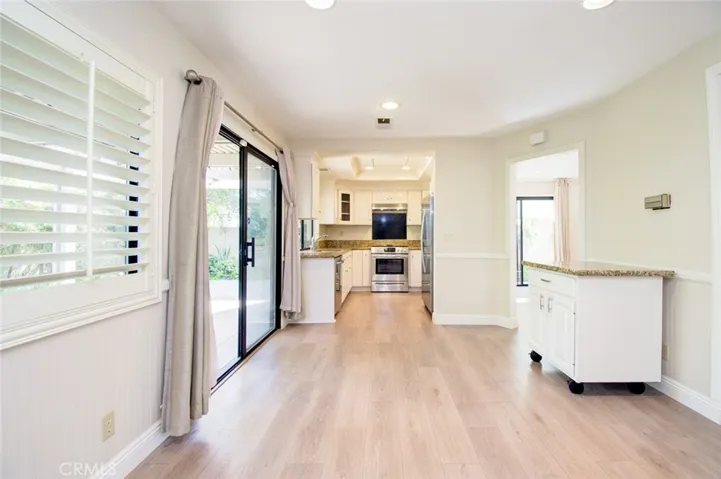 The family room is next to the remodeled kitchen with stainless steel appliances as well as a kicthen island on wheels.