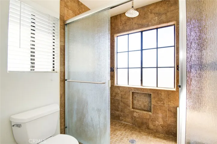 The walk-in shower in the primary bathroom.