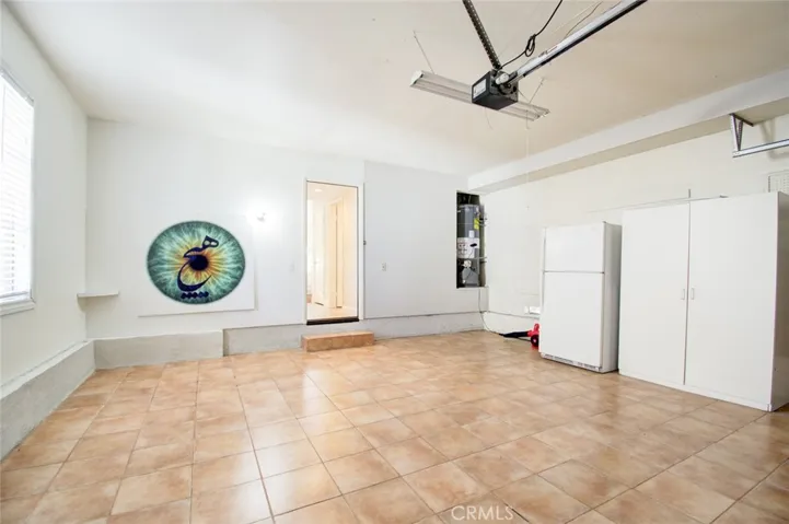 Attached garage with direct access to the house with the second refrigerator.