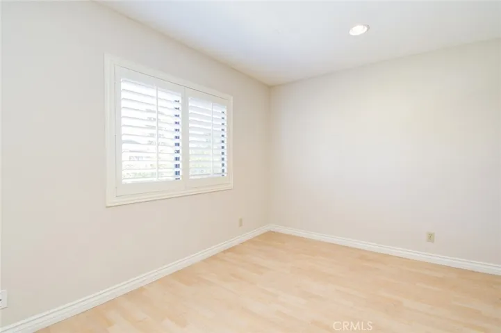 Another view of the third bedroom with recess ceiling lights.