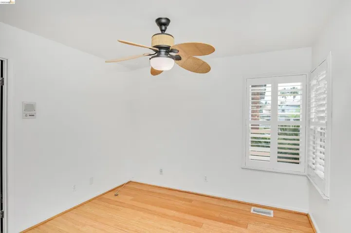 Unfurnished room featuring ceiling fan and light wood-type flooring