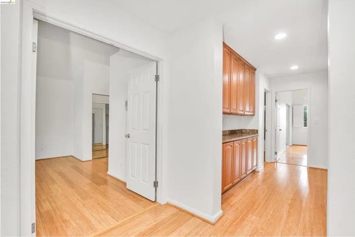 Hall featuring light wood-style floors and recessed lighting