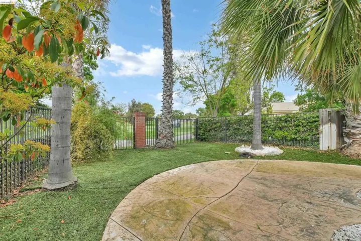 Fenced backyard with a patio