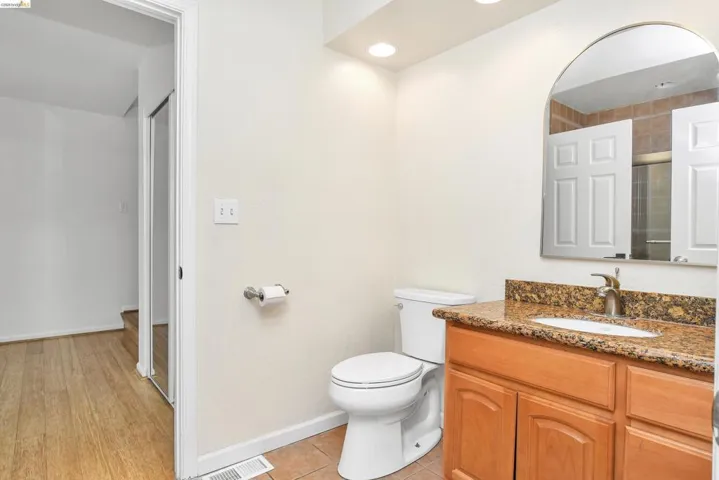 Full bath with vanity and light tile patterned floors