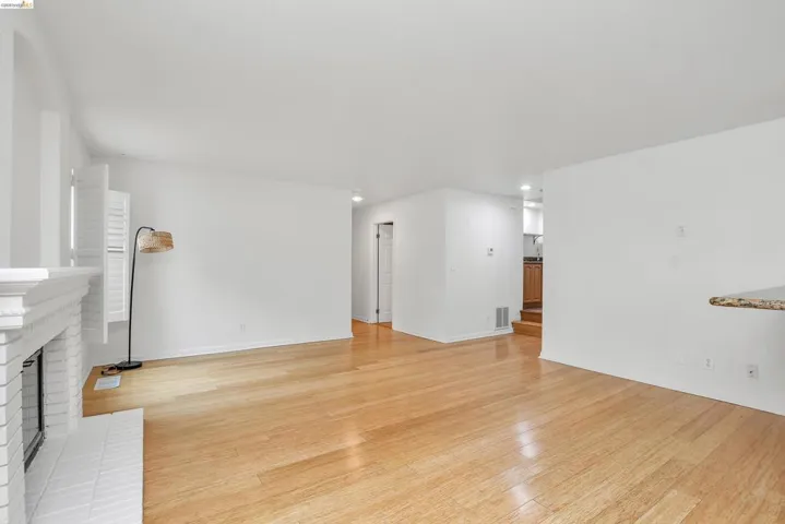 Unfurnished living room featuring light wood-style flooring, a fireplace, and recessed lighting