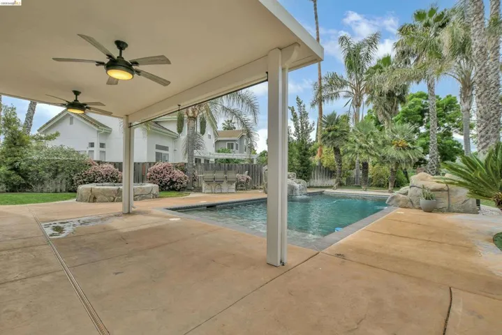 View of pool with patio surround and a fenced backyard