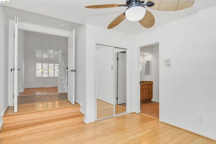 Corridor featuring light wood-style flooring and baseboards