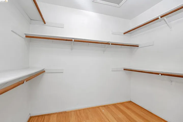 Walk in closet featuring light wood-type flooring