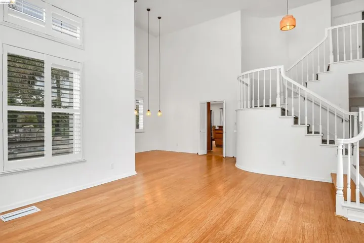 Living area with a high ceiling and light wood-type flooring
