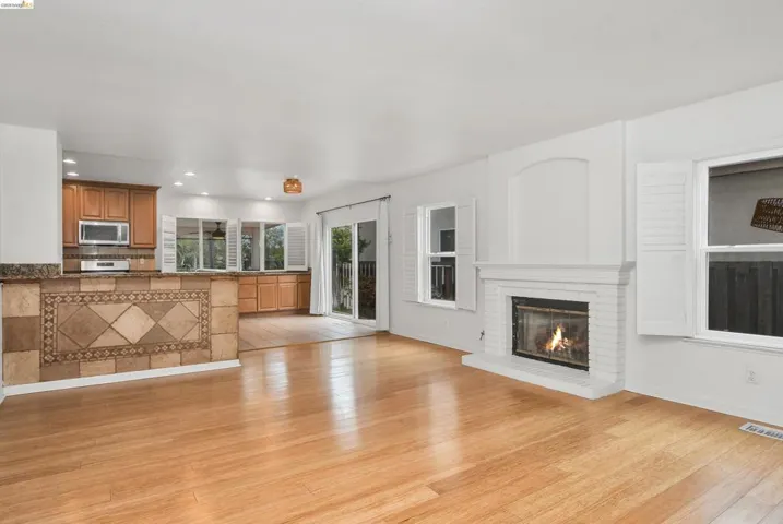 Unfurnished living room featuring light wood-style floors, a fireplace, and recessed lighting