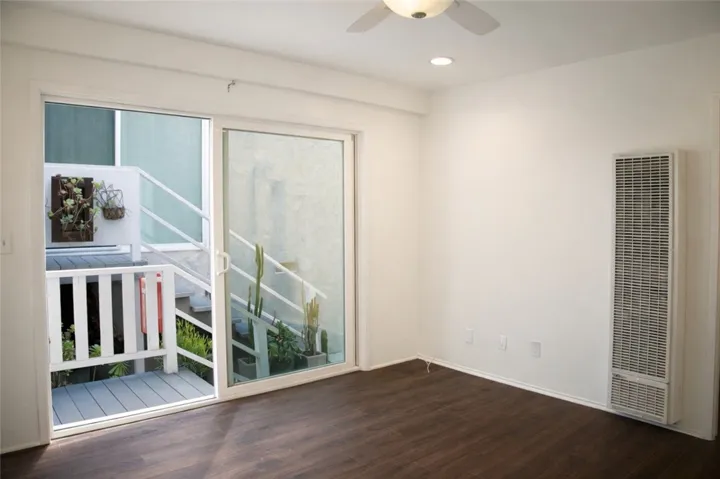 Living space featuring hardwood-style flooring and neutral finishes.