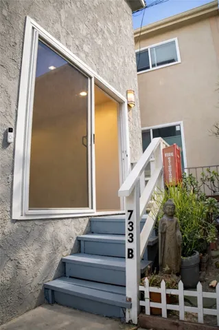 Sliding glass door entry allowing for natural light and indoor-outdoor flow.