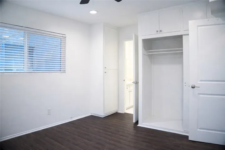 Bedroom with hardwood-style flooring and a simple, comfortable layout.