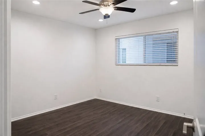 Bedroom featuring ceiling fan and natural light.