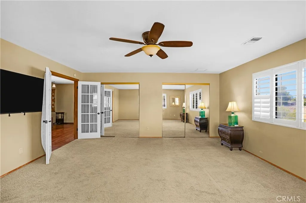 Primary bedroom shows mirrored closets