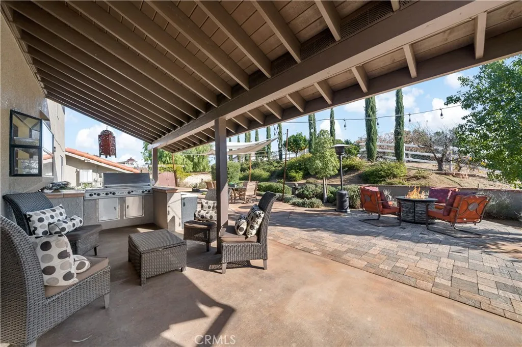 Relaxing area under patio includes BBQ area