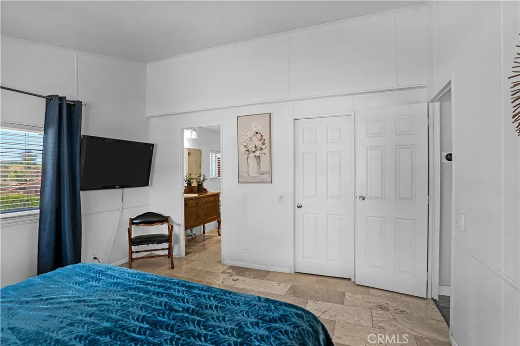 Primary bedroom faces walk-in closet and bathroom
