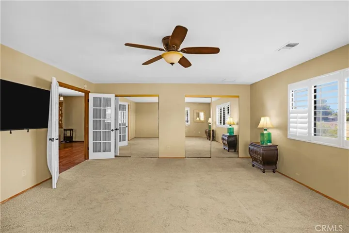 Primary bedroom shows mirrored closets