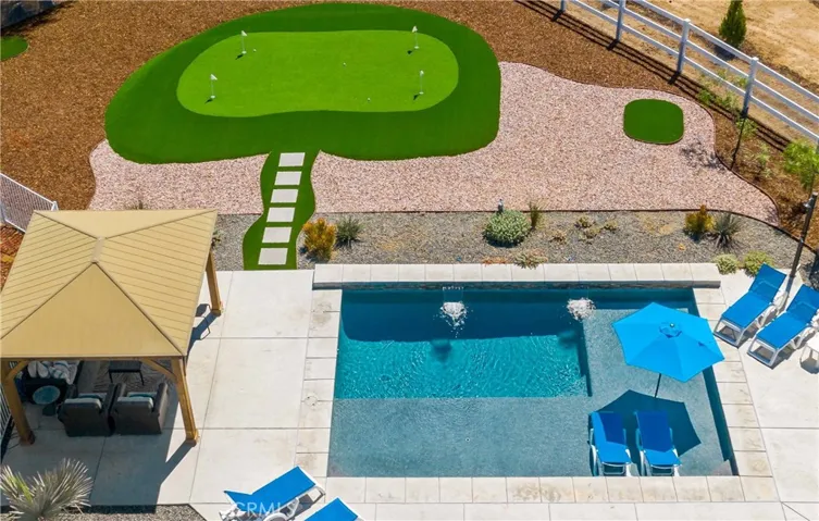 Pool, cabana, and putting green