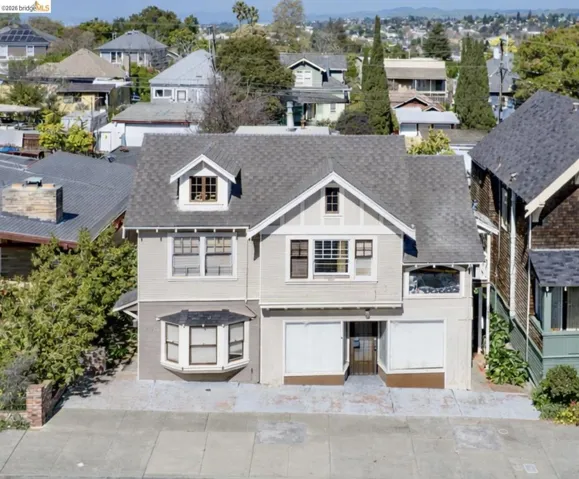 View of front of property featuring a residential view and roof with shingles
