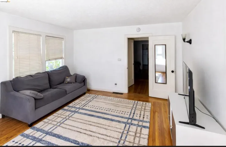 Living room featuring light wood-style floors and baseboards
