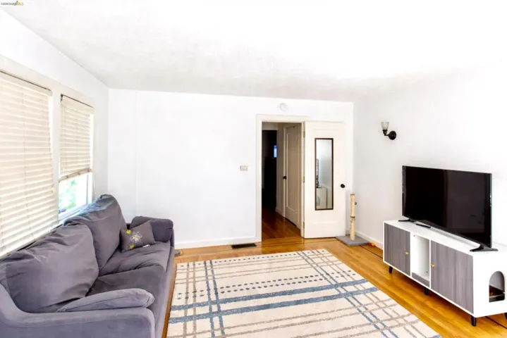 Living area featuring light wood-style floors and baseboards