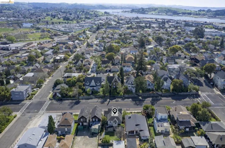Aerial overview of property's location with nearby suburban area and a nearby body of water