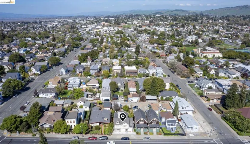 Aerial overview of property's location featuring nearby suburban area and mountains