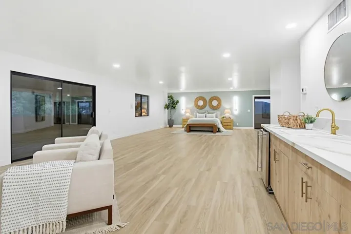 Spacious primary suite with peaceful balcony views and natural light
