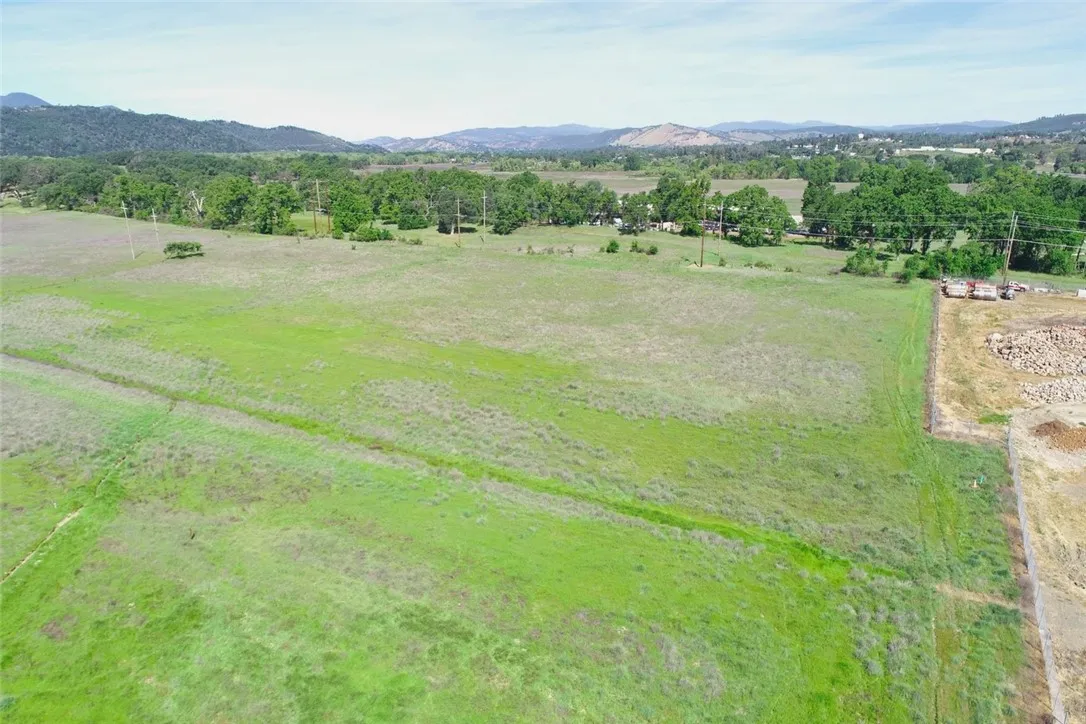 The two lots start at the L shape of the fence to the tree line