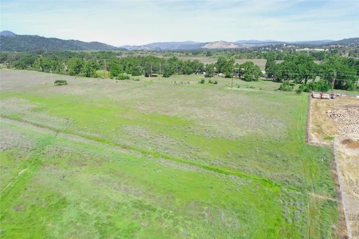 The two lots start at the L shape of the fence to the tree line