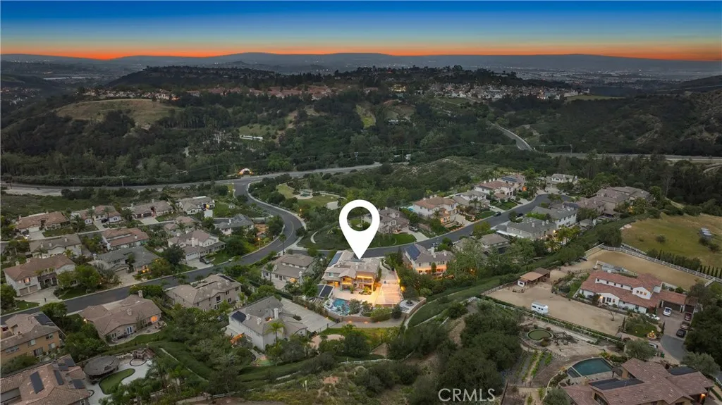 Aerial view of half acre property with pool, sports court and garden