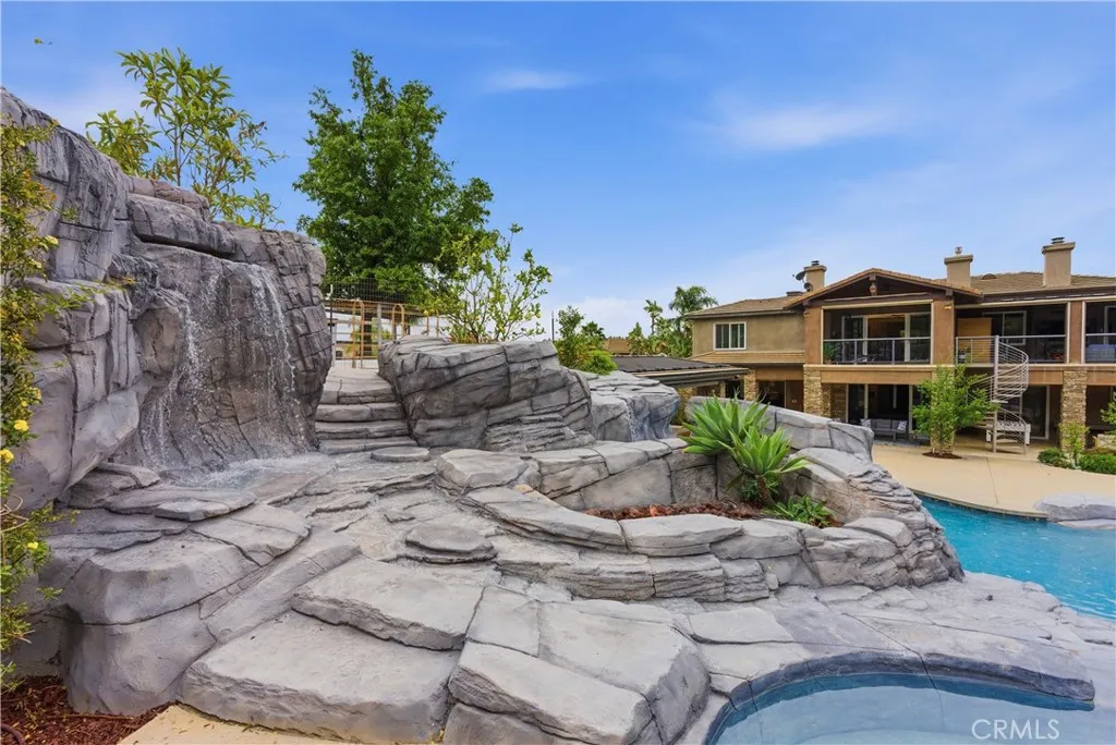 Fire pit from pool overlooking pool with waterfalls