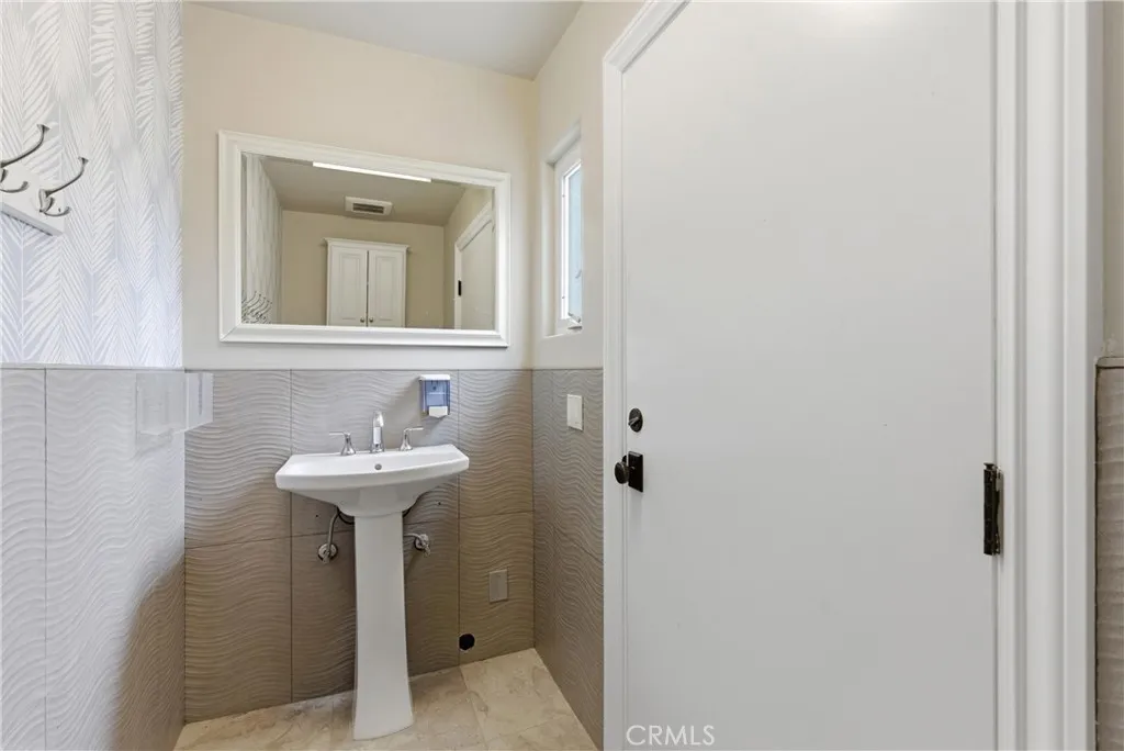 Outdoor shower and pool bathroom access from backyard