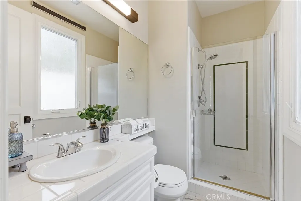Full bathroom with walk-in shower and window