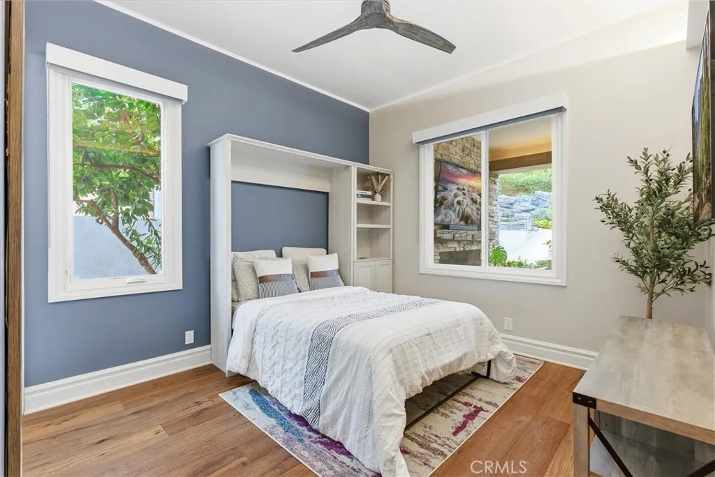 Guest bedroom with Murphy bed open and backyard view