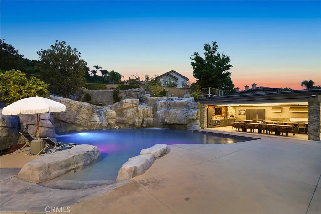 Backyard pool view looking toward the outdoor kitchen