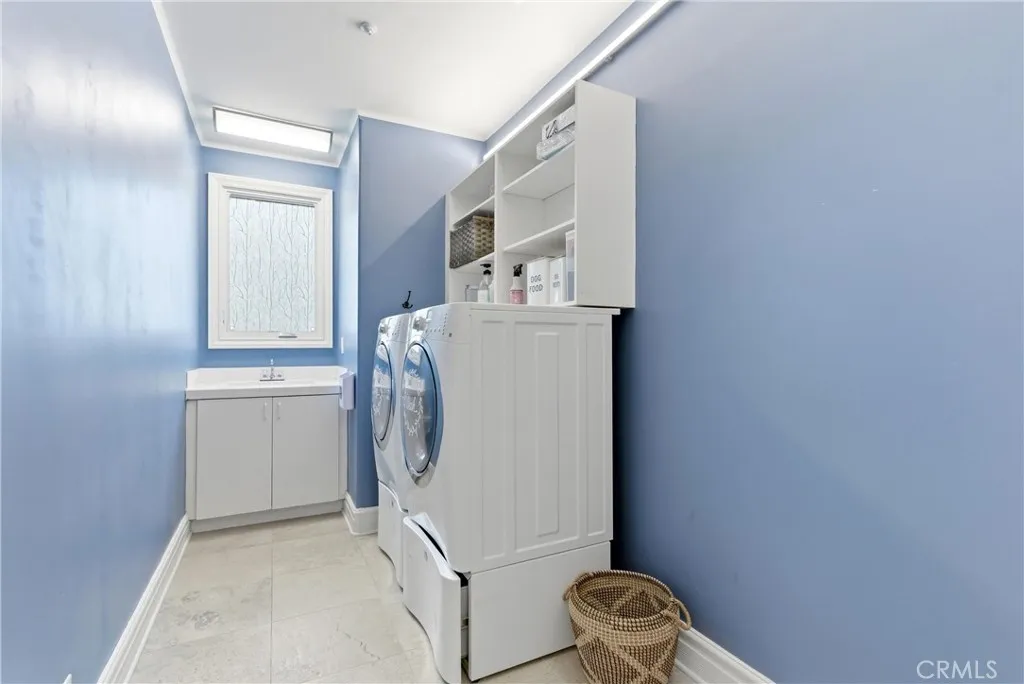 1st floor laundry room with storage cabinets and counter space