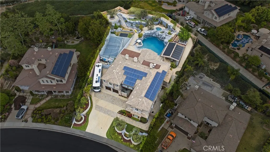 ariel view of home on half acre lot with outdoor kitchena nd pool with rockslide and diving rock