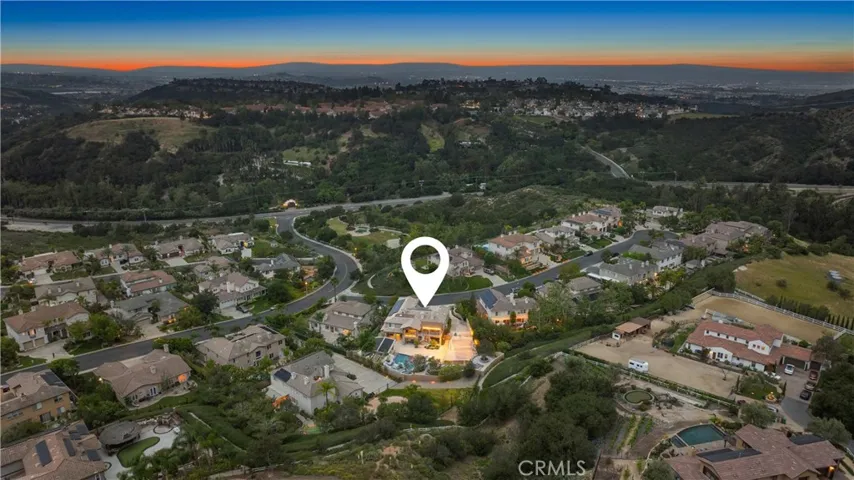 Aerial view of half acre property with pool, sports court and garden