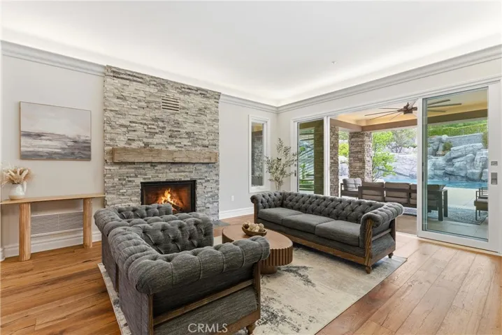 Formal living room with fireplace leading outdoors for indoor outdoor living